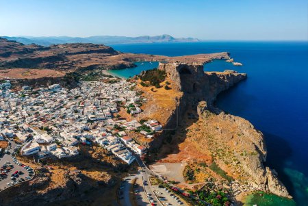 Photo for Aerial birds eye view drone photo of village Lindos, Rhodes island, Dodecanese, Greece. Sunset panorama with castle, Mediterranean sea coast. Famous tourist destination in South Europe. - Royalty Free Image