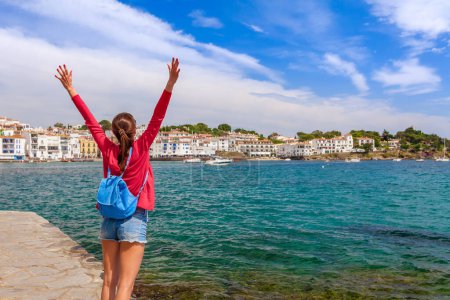 Photo for Tourist woman in Cadaques, Catalonia, Spain near of Barcelona. Scenic old town with nice beach and clear blue water in bay. Famous resort destination in Costa Brava with Salvador Dali landmark - Royalty Free Image