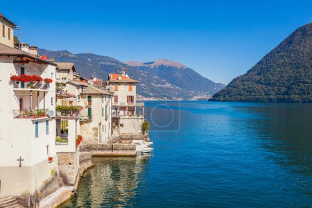 Photo for Panorama landscape on beatiful Lake Como in Brienno, Lombardy, Italy. Scenic small town with traditional houses and clear blue water. Summer tourist vacation on rich resort with harbour. Nice swans - Royalty Free Image