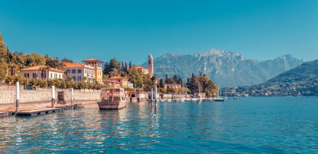 Photo for Panorama landscape on beatiful Lake Como in Tremezzina, Lombardy, Italy. Scenic small town with traditional houses and clear blue water. Summer tourist vacation on rich resort with nice harbour - Royalty Free Image