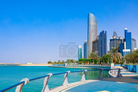 Photo for Skyline view of Abu Dhabi panorama with sea, beach and skyscrapers. Sunny summer day in Abu Dhabi - famous tourist destination in UAE. Ideal place for luxury travel and rest - Royalty Free Image