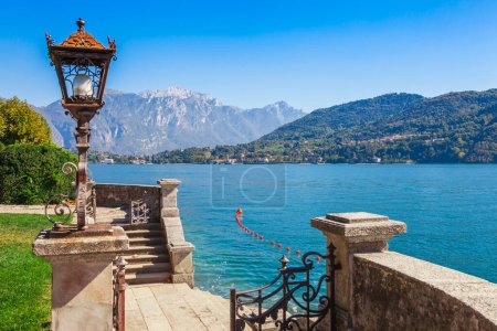 Photo for Panorama landscape on beatiful Lake Como in Tremezzina, Lombardy, Italy. Scenic small town with traditional houses and clear blue water. Summer tourist vacation on rich resort with nice harbour - Royalty Free Image