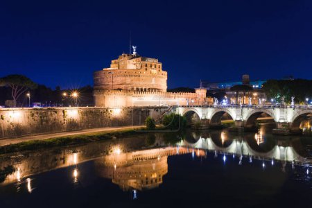 Photo for Cityscape romantic night view of Roma. Panorama with Saint Angelo castle and bridge. Famous tourist destination with Tiber. Travel illuminated landscape in Italy, Europe. - Royalty Free Image