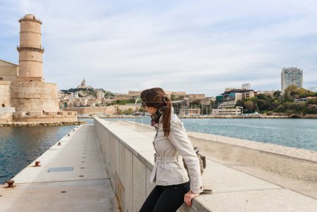 Photo for Tourist woman in French historical city Marseille and Mediterranean sea coast. Marseille is the biggest port in France, South Europe. Famous large city and tourist destionation. - Royalty Free Image