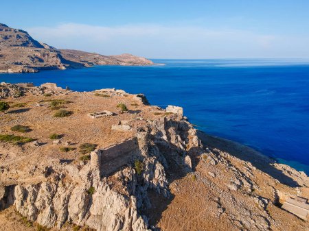 Photo for Aerial birds eye view drone photo Feraklos castle near Agia Agathi beach on Rhodes island, Dodecanese, Greece. Panorama with sand and clear blue water. Famous tourist destination in South Europe - Royalty Free Image