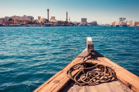 Photo for Panoramic view from traditional water taxi boats in Dubai, UAE. Creek gulf and Deira area. United Arab Emirates famous tourist destination. Creative color post processing. - Royalty Free Image