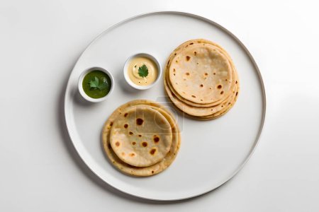AI Generated-Aloo Paratha / Indian Potato stuffed Flatbread. Served with fresh fresh Lassi / Lassie or buttermilk. Aloo Paratha / Indian Potato stuffed Flatbread with butter on top. Served with fresh sweet Lassi, chutney and pickle . selective focus