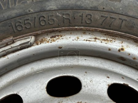 Photo for Closeup of text 165/65 showing width and aspect ratio of a tyre. - Royalty Free Image