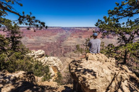 Photo for Pretty female enjoys vantage point view on Grand Canyon Arizona, USA. Grand Canyon, USA - September 27, 2018. - Royalty Free Image