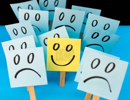 Sticky notes with hand drawn Smiley face and Sad faces. Positive way of thinking concept. Positive mind overcomes negative