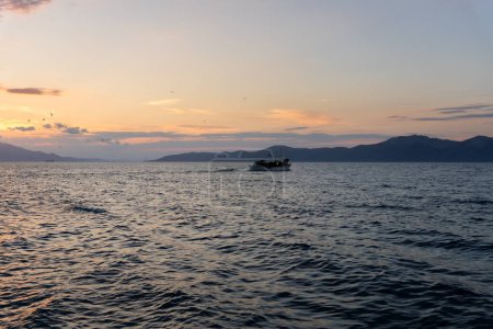Fishing Boat at sea in Evia island in Greece at sunset