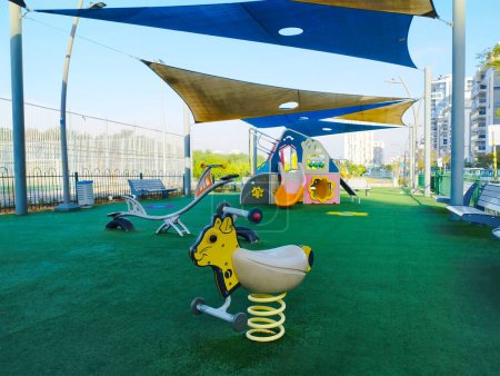Foto de Parque infantil en Israel, en amarillo y azul con césped artificial - Imagen libre de derechos