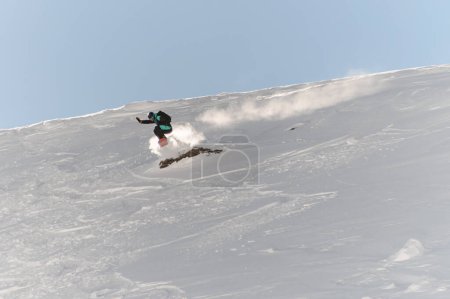 Photo for Great view on active male freerider on snowboard speedly descends an off-piste on fresh snow of mountain hill - Royalty Free Image