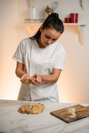 Photo for Confectioner prepares dough for the pie and further baking in the oven at a hot temperature for decoration for the holidays - Royalty Free Image