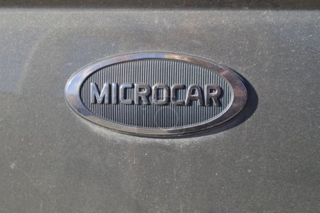 Photo for Close-up of the logo of a Microcar brand moped, a manufacturer of automobiles that can be driven without a driver's license - Royalty Free Image