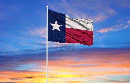  Texas flag on flagpoles and blue sk