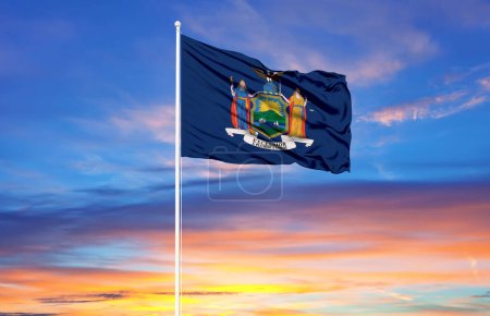 Foto de Bandera de Nueva York en asta de bandera y cielo azul. Concepto patriótico sobre el estado. - Imagen libre de derechos