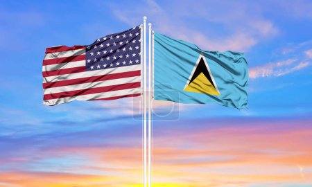 Photo for United States and Saint Lucia two flags on flagpoles and blue cloudy sky . Diplomacy concept, international relations - Royalty Free Image