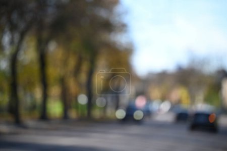 Photo for Defocused background of blurred city road near autumn park - Royalty Free Image