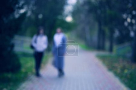Photo for Blurred view of people walking in city park - Royalty Free Image