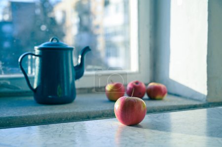 Photo for Fresh ripe apples  and pot on a windowsill - Royalty Free Image