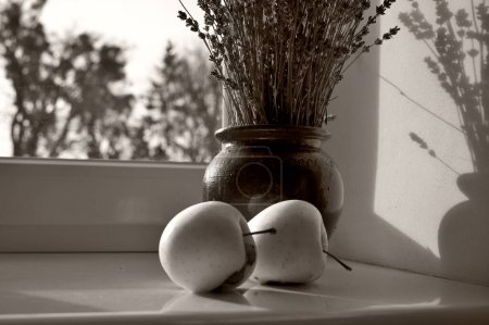 Photo for Apples and lavenders in the vase on windowsill - Royalty Free Image