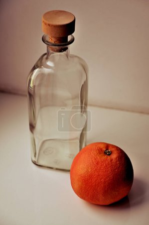 Photo for Fresh orange and empty  bottle  on windowsill - Royalty Free Image