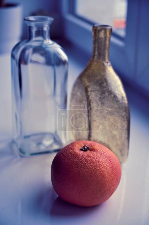 Photo for Fresh orange and empty  bottles on table - Royalty Free Image