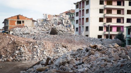 Foto de Earthquake damage in a city. Destroyed buildings after an earthquake. Collapsed buildings. Ruined city because of war. Airstrike damages a city. Urban transformation concept. Selective focus included - Imagen libre de derechos