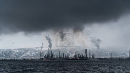 Photo for Environmental pollution. Toxic chemical gases releasing to atmosphere from oil refinery plant. Selective focus included. Noise and grain included - Royalty Free Image