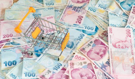 Photo for Cost of living concept. Empty cart on a stack of Turkish liras. Inflation rising in Turkey. Economic crisis. Rising costs in daily life - Royalty Free Image