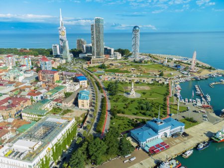 Photo for Drone view of a part of the city and the sea of the pier on a sunny day in Batumi. Beautiful urban landscape on the Black Sea coast - Royalty Free Image