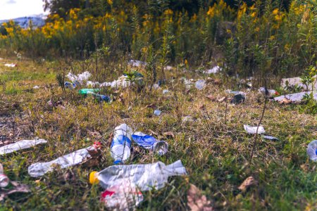 Photo for Close-up of plastic bottles, garbage in the grass. Illegal dumping of garbage in nature. Pollution of the environment by garbage. Concept of an ecological catastrophe on the planet - Royalty Free Image