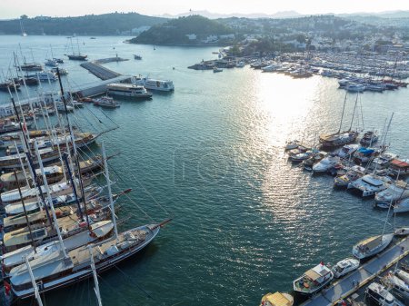 Magnificent drone view of the beautiful, yacht-filled harbor of Bodrum in Mugla province in Turkey at sunset.