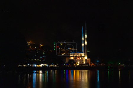 Illuminated mosque on Uzungol Lake at night, Turkey. Concept of travel, religion
