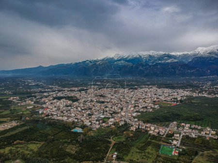 Foto de Vista aérea de la ciudad de Sparti Grecia con la nevada montaña Taygetus en el fondo Laconia, Grecia, Europa - Imagen libre de derechos