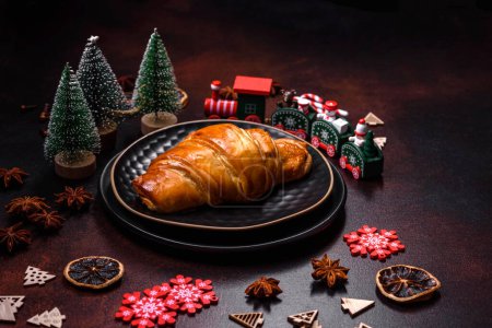 Photo for Beautiful different Christmas decorations and croissant on a brown concrete table. Preparation for New Year's celebrations - Royalty Free Image