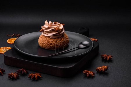 Delicious sweet shu cake with cream and nuts on a dark concrete background