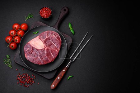 Photo for Fresh beef ossobuco steak with salt, spices and herbs on textured concrete background - Royalty Free Image