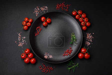 Photo for Ingredients for cooking cherry tomatoes, salt, spices and herbs on a dark concrete background - Royalty Free Image