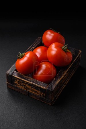 Photo for Delicious fresh juicy tomatoes on a dark concrete background. Sauce Ingredients - Royalty Free Image