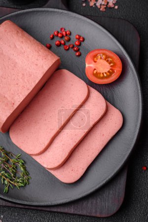 Photo for Delicious canned pink ham with salt, spices and herbs on a dark concrete background - Royalty Free Image