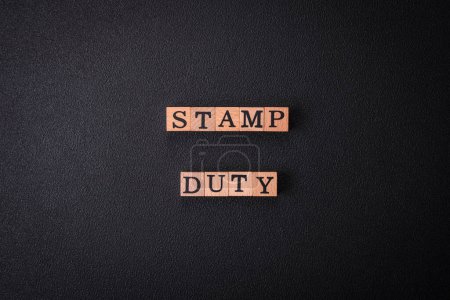 Photo for The inscription Stamp Duty made of wooden cubes on a plain background. Can be used for your design - Royalty Free Image