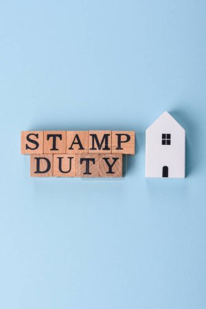 The inscription Stamp Duty made of wooden cubes on a plain background. Can be used for your design