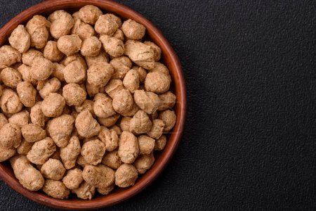 Dry soybean meat pellets, diet food for vegan and vegetarian cuisine on dark concrete background