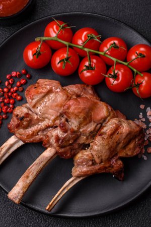 Delicious juicy meat on the bone or rack of lamb or grilled veal with salt, spices and herbs