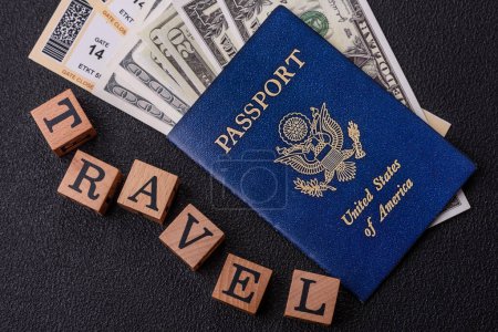 United states of america passport, airline tickets and money on a dark concrete background. Conceptual background on the theme of tourism and travel