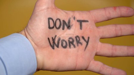 Foto de Business man with write Don't worry be happy , Time is now ( carpe diem ) - positive message in hand and lifestyle - Imagen libre de derechos