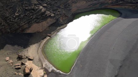 Photo for Europe, Spain, Lanzarote, Canary Islands - Charco de Los Clicos (Charco Verde) drone aerial view of green lagoon in Tymanfaya national park, Volcanic landscape - tourist attraction in biosphere reserve - Royalty Free Image
