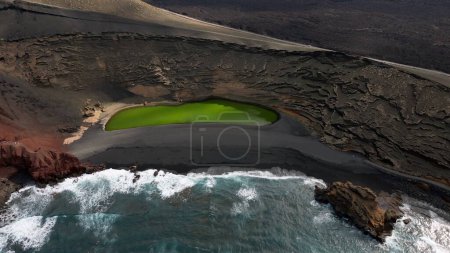 Photo for Europe, Spain, Lanzarote, Canary Islands - Charco de Los Clicos (Charco Verde) drone aerial view of green lagoon in Tymanfaya national park, Volcanic landscape - tourist attraction in biosphere reserve - Royalty Free Image